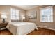 Bright bedroom with hardwood floors, large windows, and neutral wall tones at 7021 Warwick Rd, Indianapolis, IN 46220