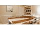 Dining room is styled with a wooden herringbone pattern table and built-in shelving at 7021 Warwick Rd, Indianapolis, IN 46220