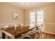 Bright dining room features a large wood table, chrome chairs, French doors, and a decorative chandelier at 7021 Warwick Rd, Indianapolis, IN 46220