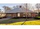 Charming red brick home with gray shutters, attached garage and well maintained lawn at 7021 Warwick Rd, Indianapolis, IN 46220