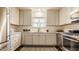 Modern kitchen with white cabinets, stainless steel appliances and hardwood floors at 7021 Warwick Rd, Indianapolis, IN 46220