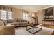 Cozy living room with neutral decor, plush sofa, hardwood floors and lots of natural light at 7021 Warwick Rd, Indianapolis, IN 46220