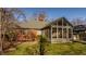 The house features a sunroom with multiple windows and a brick exterior with a well manicured lawn at 7021 Warwick Rd, Indianapolis, IN 46220