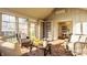 Light-filled sunroom with wicker seating, brick flooring, and built-in bookshelves at 7021 Warwick Rd, Indianapolis, IN 46220