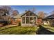 The exterior of the house features a sunroom with multiple windows and a brick exterior at 7021 Warwick Rd, Indianapolis, IN 46220