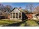 The exterior of the house features a sunroom with multiple windows at 7021 Warwick Rd, Indianapolis, IN 46220