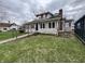 Two-story home with a ramp leading to the front door, red shutters, and a chimney against a cloudy sky at 805 W 3Rd St, Alexandria, IN 46001