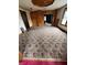 Spacious living room with carpet, wood paneling, a doorway leading to another room, and natural light from windows at 805 W 3Rd St, Alexandria, IN 46001