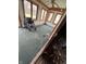 Sun room with a wheelchair next to windows, peeling wallpaper, and light coming in at 805 W 3Rd St, Alexandria, IN 46001