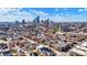 Stunning aerial view featuring the city skyline rising behind neighborhood houses on a beautiful, sunny day at 932 Broadway St # 15, Indianapolis, IN 46202