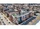 Aerial view showcases the neighborhood's architecture and street layout of residential buildings, streets and parked cars at 932 Broadway St # 15, Indianapolis, IN 46202