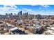 Breathtaking aerial view of the city skyline with a mix of residential buildings and a green skyline backdrop at 932 Broadway St # 15, Indianapolis, IN 46202