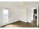 Bedroom featuring wood floors, closet space and exterior door for balcony access at 932 Broadway St # 15, Indianapolis, IN 46202
