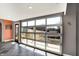 Unique hallway featuring a glass garage-style door offering abundant natural light and outdoor views with slate tile flooring at 932 Broadway St # 15, Indianapolis, IN 46202