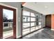 Hallway featuring a glass garage-style door, tile floors and view of the outdoors, blending indoor aesthetics with outdoor scenery at 932 Broadway St # 15, Indianapolis, IN 46202