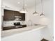 Kitchen showcasing marble countertops, stainless steel appliances, dark wood cabinets and modern pendant lights at 932 Broadway St # 15, Indianapolis, IN 46202