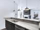 Kitchen featuring marble counters, stainless steel appliances and sink, and modern pendant lighting at 932 Broadway St # 15, Indianapolis, IN 46202
