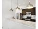 Kitchen features marble countertops, stainless steel appliances, modern cabinetry and pendant lighting at 932 Broadway St # 15, Indianapolis, IN 46202