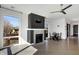 Spacious living area with a decorative fireplace, ample light, and modern ceiling fan at 932 Broadway St # 15, Indianapolis, IN 46202