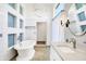 Luxurious bathroom with an oval tub, white cabinets and mosaic floors at 932 Broadway St # 15, Indianapolis, IN 46202