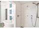 Modern bathroom with walk-in shower, oval tub, and bright white tile at 932 Broadway St # 15, Indianapolis, IN 46202