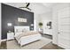 Beautiful bedroom with a shiplap accent wall, ceiling fan, and white furniture set at 932 Broadway St # 15, Indianapolis, IN 46202