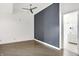 Large bedroom with accent wall, hardwood floors, and a view of the bathroom at 932 Broadway St # 15, Indianapolis, IN 46202