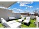 Stylish rooftop patio furnished with white outdoor seating, offering a sleek and modern space for relaxation and entertainment at 932 Broadway St # 15, Indianapolis, IN 46202