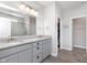 Bathroom featuring double vanity with granite countertop, walk-in tiled shower, and wood-look flooring at 981 Mound St, Bargersville, IN 46106