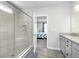 Modern bathroom with a glass-enclosed shower, granite countertop, and wood-look floors at 981 Mound St, Bargersville, IN 46106