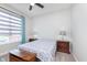Cozy bedroom featuring neutral walls, ceiling fan and a bright window for natural light at 981 Mound St, Bargersville, IN 46106