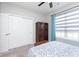 Bright bedroom features a closet, ceiling fan and a sunlit window at 981 Mound St, Bargersville, IN 46106