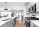 Modern kitchen featuring stainless steel appliances, subway tile backsplash, and a view into the dining area at 981 Mound St, Bargersville, IN 46106
