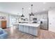 A spacious kitchen featuring an island with pendant lighting, stainless steel appliances, and a pantry at 981 Mound St, Bargersville, IN 46106