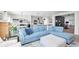 Open-concept living room with a stylish sofa and open access to the kitchen and dining area at 981 Mound St, Bargersville, IN 46106