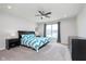 A bright and airy main bedroom with a ceiling fan, neutral walls, and carpet flooring at 981 Mound St, Bargersville, IN 46106