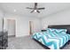 Inviting bedroom featuring a ceiling fan, a cozy bed, and neutral-colored walls and carpets at 981 Mound St, Bargersville, IN 46106