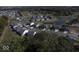 Aerial view of a well-planned community featuring modern homes, green spaces, and a tranquil pond at 10609 Banyan Wood Ct, Indianapolis, IN 46239