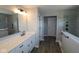 Modern bathroom featuring a double vanity sink, with sleek fixtures and a glass enclosed shower at 10609 Banyan Wood Ct, Indianapolis, IN 46239