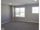 A bright bedroom featuring neutral walls, plush gray carpeting, and natural light from energy-efficient windows at 10609 Banyan Wood Ct, Indianapolis, IN 46239