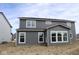 The rear exterior showcases a modern home with large windows and gray siding at 10609 Banyan Wood Ct, Indianapolis, IN 46239