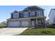 Charming two-story home with a three-car garage and a well-manicured lawn, perfect for curb appeal at 10609 Banyan Wood Ct, Indianapolis, IN 46239