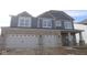 New two-story home with a gray brick facade and attached two-car garage at 10609 Banyan Wood Ct, Indianapolis, IN 46239