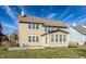 Back exterior of a two-story home with a well-maintained lawn and a charming patio seating area for outdoor enjoyment at 12729 Brandenburg Dr, Carmel, IN 46032