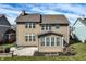 Spacious backyard featuring a stone patio, mature landscaping, and outdoor living space at 12729 Brandenburg Dr, Carmel, IN 46032