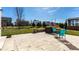 Expansive backyard featuring a manicured lawn, stone patio with grill, and elegant outdoor seating for relaxing and entertaining at 12729 Brandenburg Dr, Carmel, IN 46032