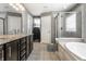 Bathroom showcasing double vanity, glass shower, and separate bathtub at 12729 Brandenburg Dr, Carmel, IN 46032