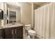 Bathroom with dark cabinets, a granite countertop, and a shower with a white curtain at 12729 Brandenburg Dr, Carmel, IN 46032