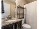 Bathroom featuring dark wood vanity, sink, and walk in shower at 12729 Brandenburg Dr, Carmel, IN 46032