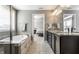 Bathroom featuring tub, double vanity, and view into main bedroom at 12729 Brandenburg Dr, Carmel, IN 46032